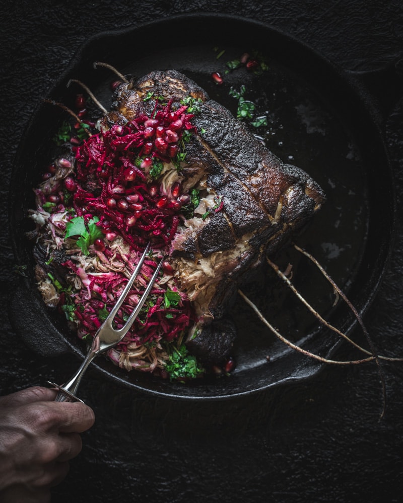 Close up of pork roast being impaled with fork