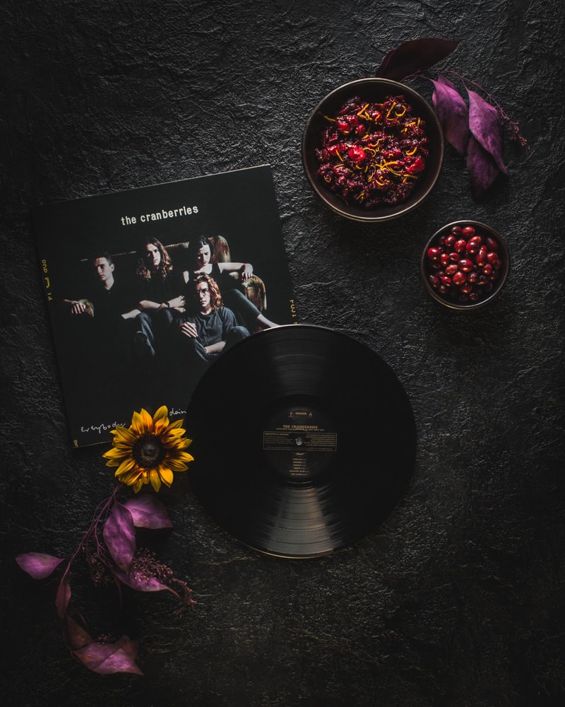 The Cranberries vinyl record with bowl of low sugar chutney spiced cranberry sauce