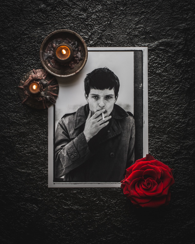 Ian Curtis memorial grave with candles and roses