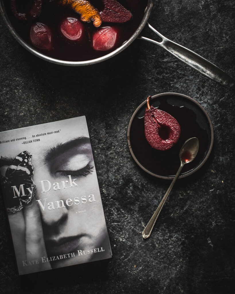 Mulled wine poached pears with My Dark Vanessa book