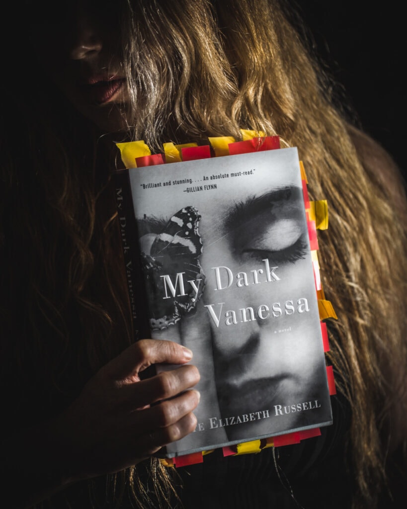 Courtney Whitman holding My Dark Vanessa Book 